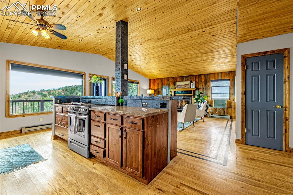 845 Crystal Park Road Manitou Springs, CO 80829 - Photo 12 of 50 a open kitchen with stainless steel appliances granite countertop a stove a sink and a wooden floors