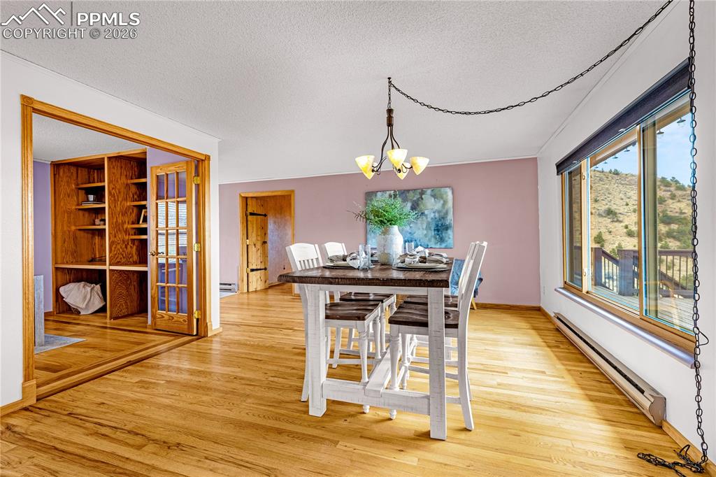 845 Crystal Park Road Manitou Springs, CO 80829 - Photo 14 of 50 a view of a dining room with furniture window and wooden floor