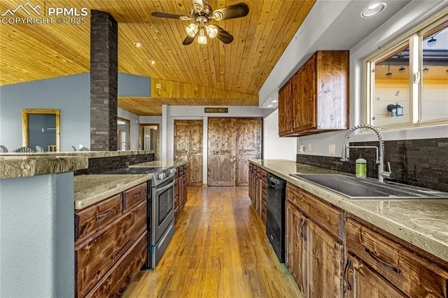 a kitchen with stainless steel appliances a stove and wooden cabinets