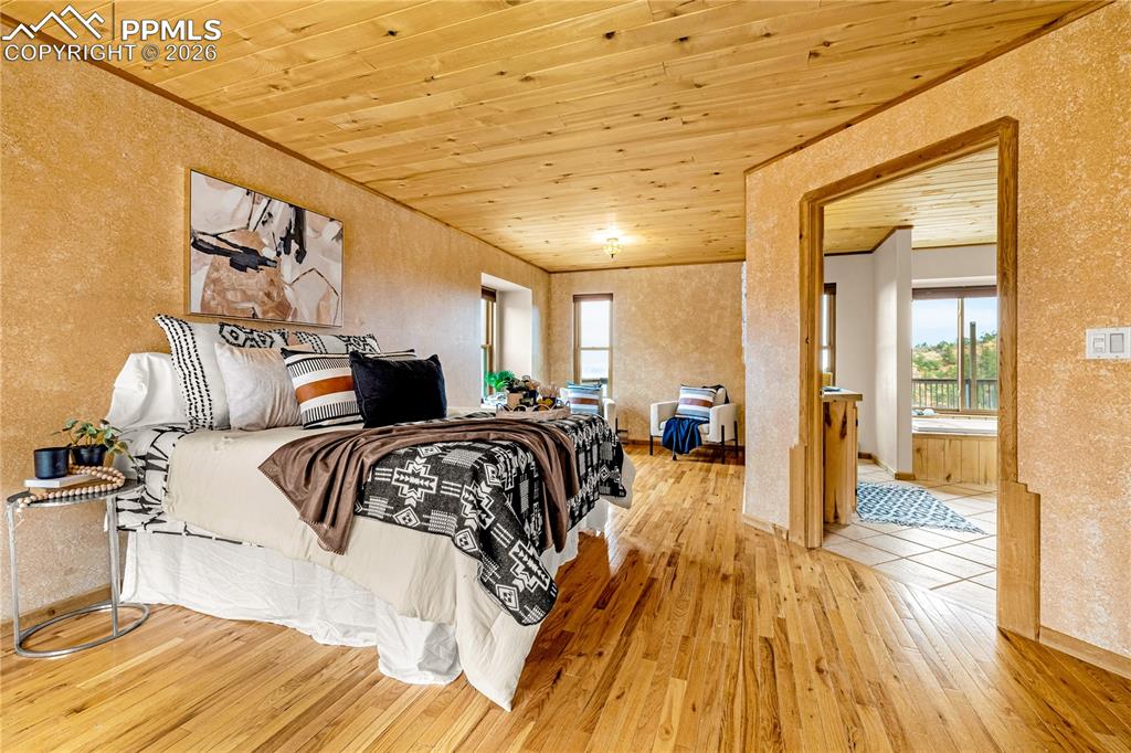 845 Crystal Park Road Manitou Springs, CO 80829 - Photo 20 of 50 a bedroom with a bed and wooden floor