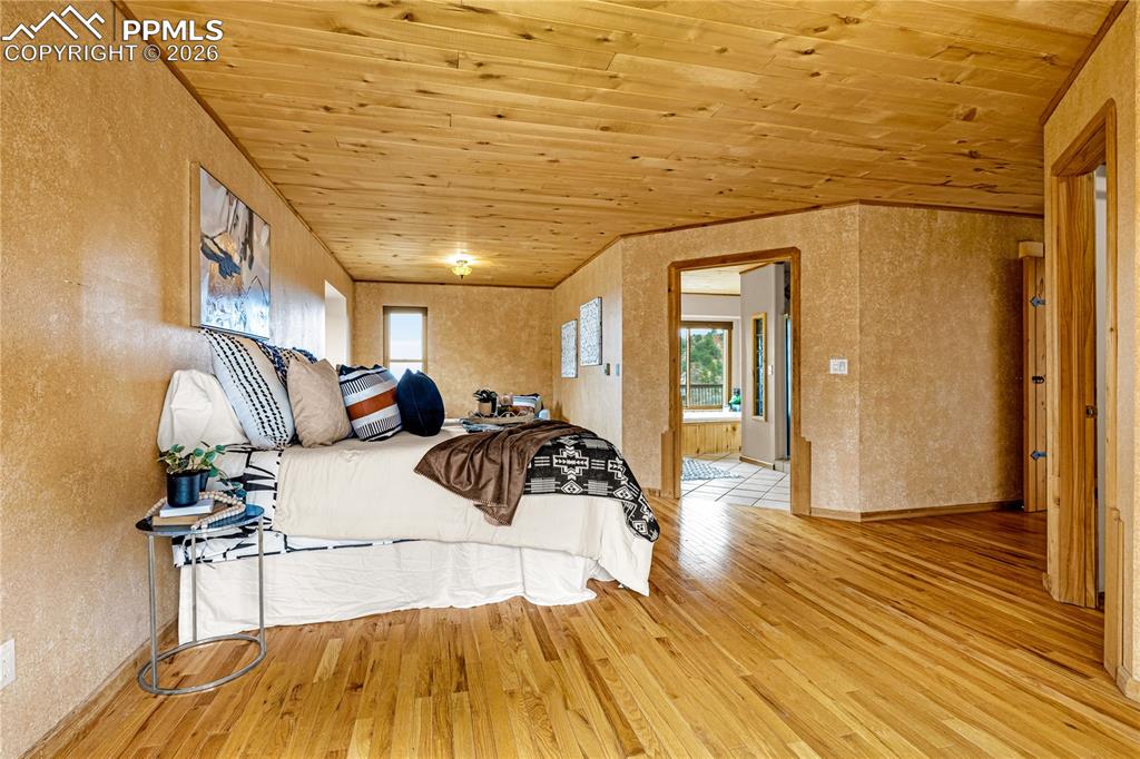 845 Crystal Park Road Manitou Springs, CO 80829 - Photo 21 of 50 a bedroom with a bed and wooden floor