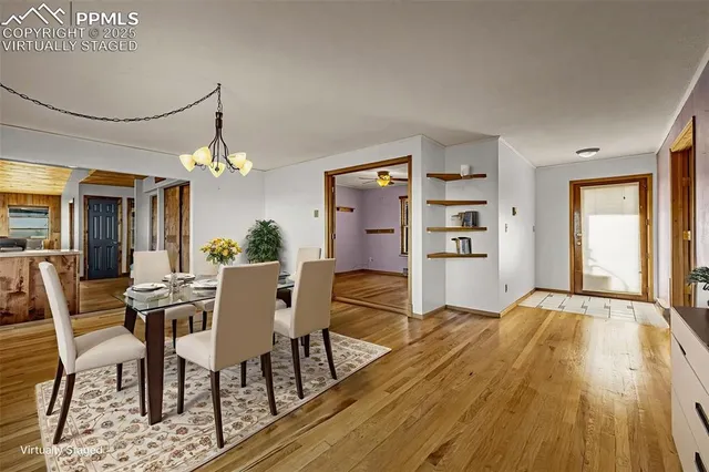 a dining room with furniture window and wooden floor