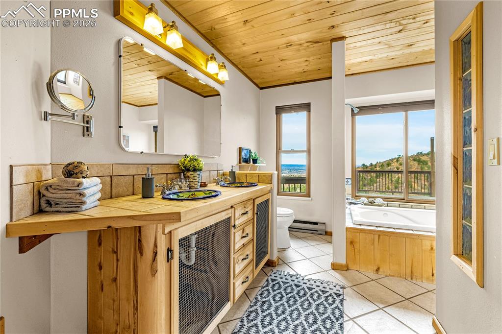 845 Crystal Park Road Manitou Springs, CO 80829 - Photo 24 of 50 a kitchen with a sink and a stove next to a window