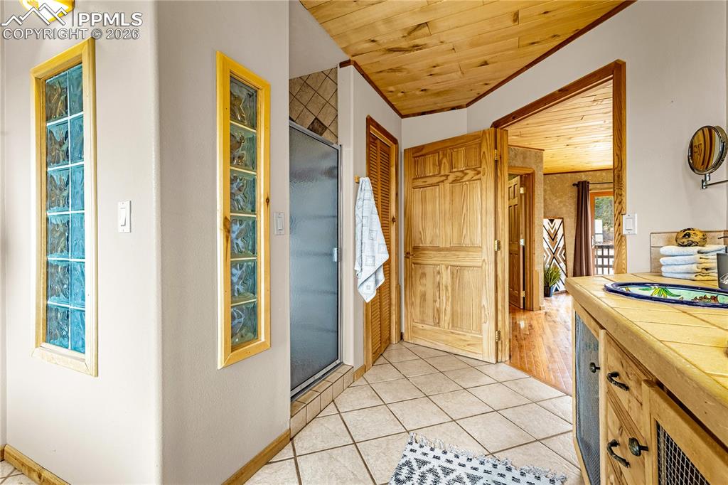 845 Crystal Park Road Manitou Springs, CO 80829 - Photo 25 of 50 a bathroom with a granite countertop sink and a mirror