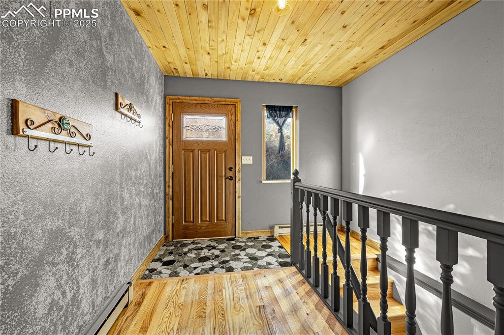 845 Crystal Park Road Manitou Springs, CO 80829 - Photo 29 of 50 a bedroom with a bed and wooden floor