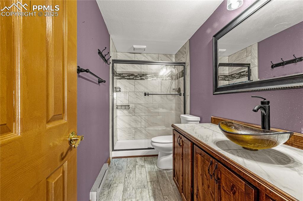 845 Crystal Park Road Manitou Springs, CO 80829 - Photo 33 of 50 a bathroom with a sink a toilet and shower