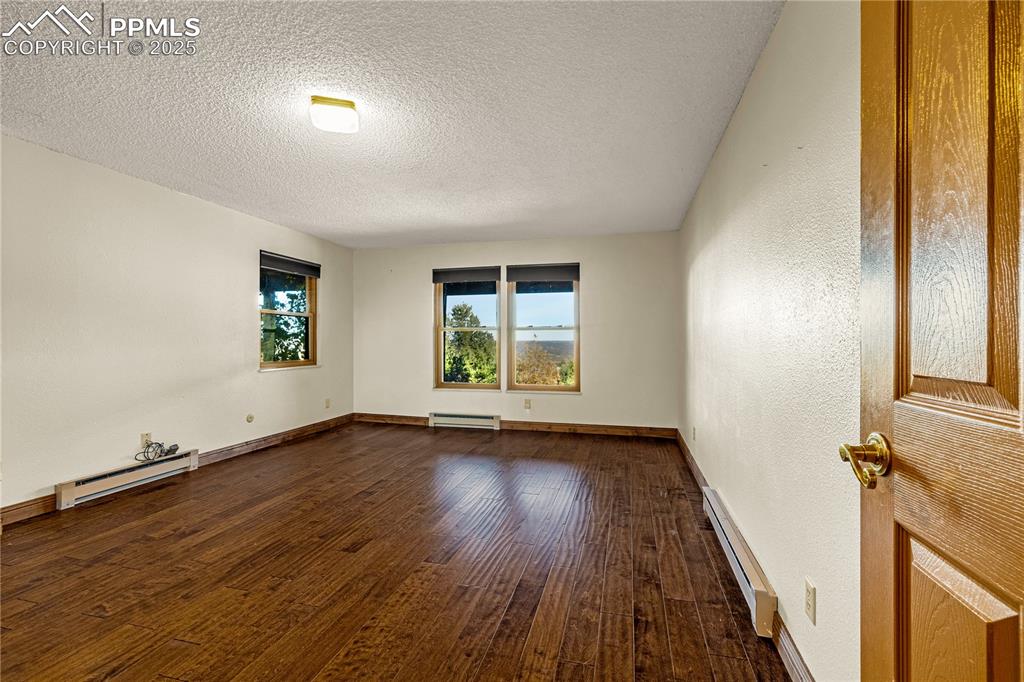 845 Crystal Park Road Manitou Springs, CO 80829 - Photo 35 of 50 an empty room with wooden floor and windows
