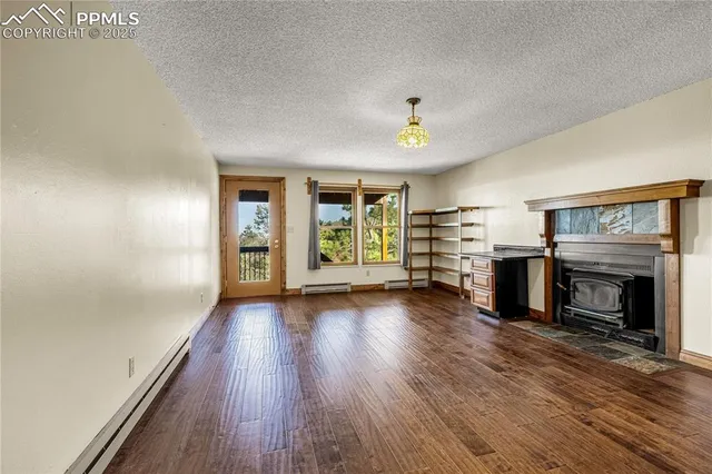 a view of a livingroom with wooden floor and a ceiling fan