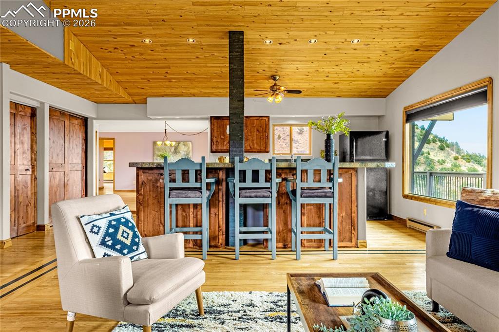 845 Crystal Park Road Manitou Springs, CO 80829 - Photo 9 of 50 a living room with fireplace furniture and a large window