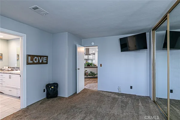 a view of a livingroom with an empty space and a flat screen tv