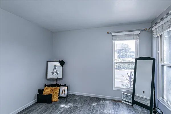 a view of room with window and wooden floor