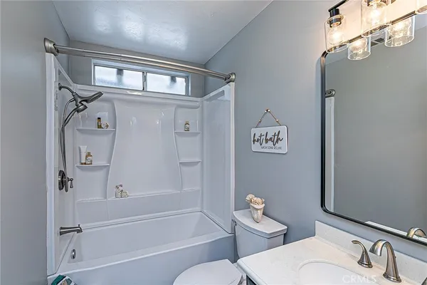 a bathroom with a toilet a sink and bathtub