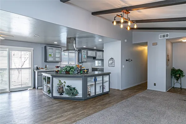 a view of living room kitchen with furniture and wooden floor