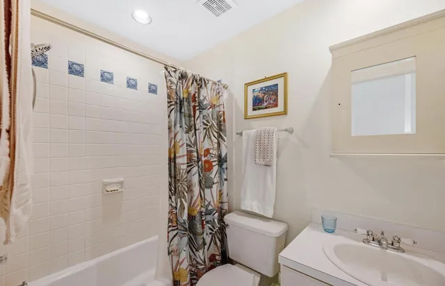a bathroom with a toilet sink and shower