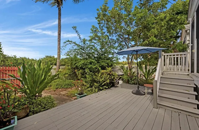a view of a deck with wooden floor and fence