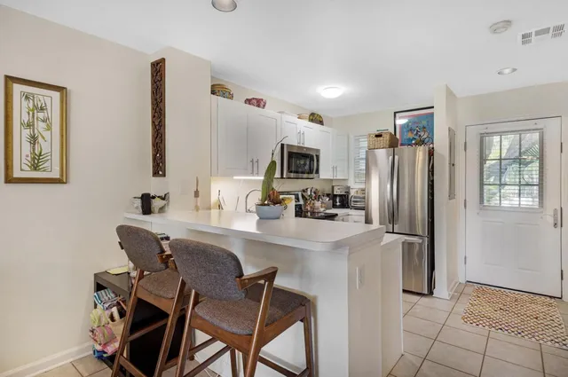a kitchen with stainless steel appliances a refrigerator and a stove top oven