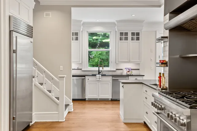 a kitchen with a sink stove and refrigerator