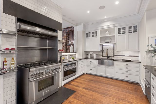 a kitchen with a stove oven and sink