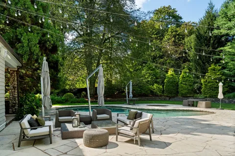 a view of a patio with couches and a table and chairs with garden view