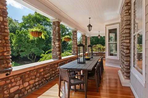a dining room with furniture window and wooden floor