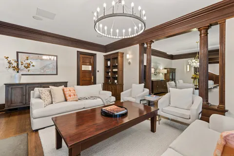 a living room with furniture a dining table and a large window
