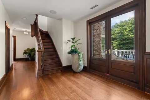 a view of entryway with wooden floor and stairs