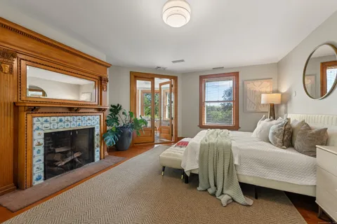 a bedroom with a bed and a fireplace