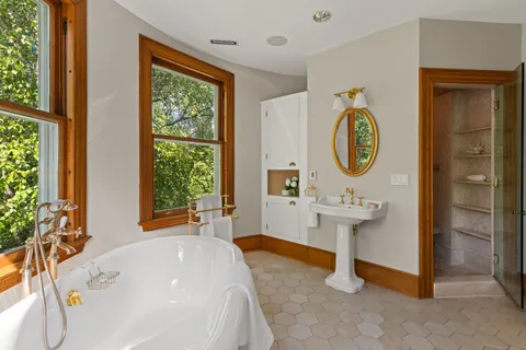 a bathroom with a sink a mirror and a window