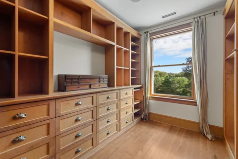 a view of room with window and cabinet