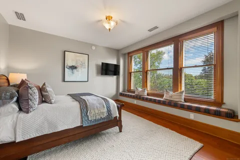 a bedroom with a large bed and a large window