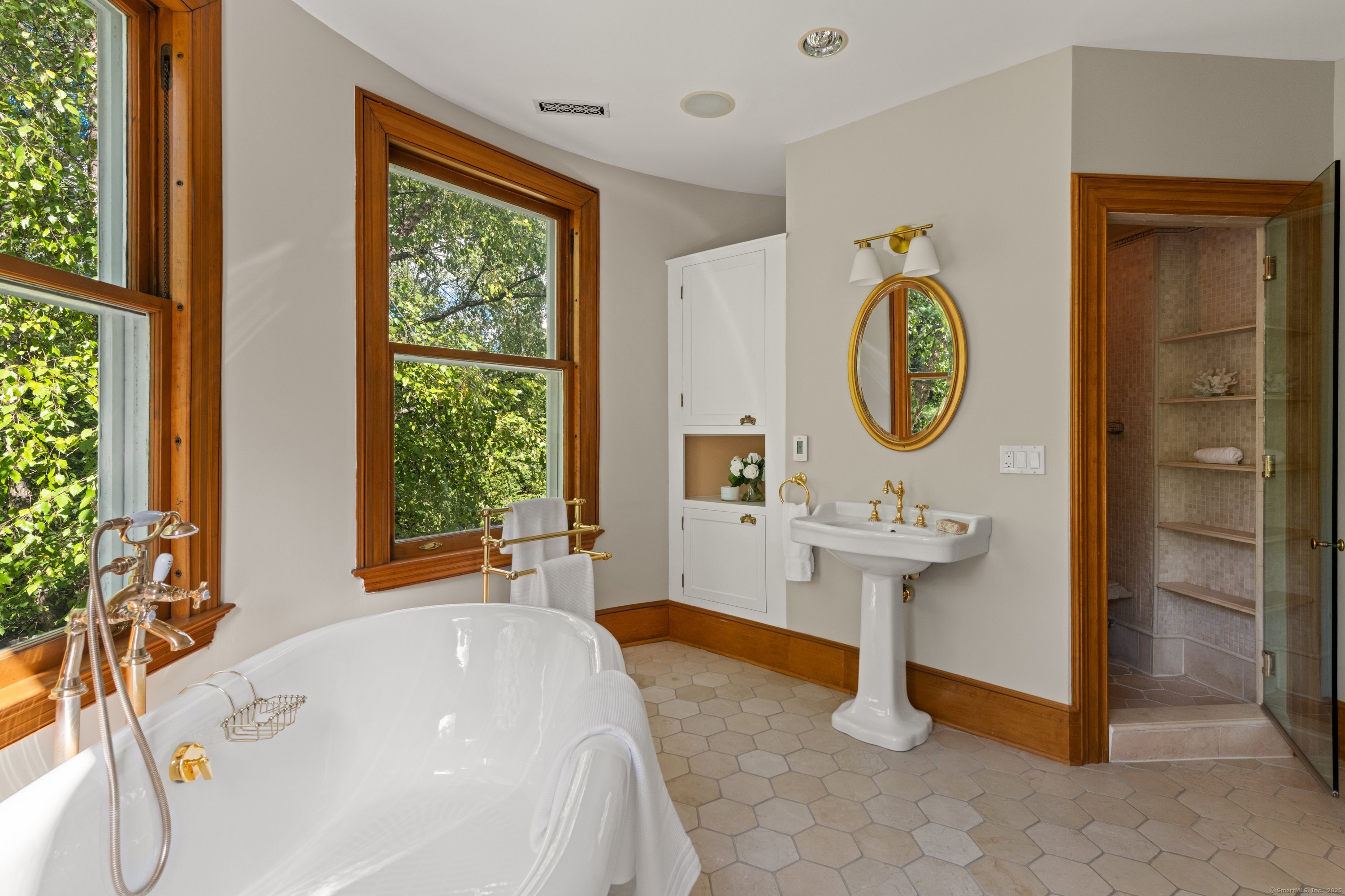 249 Greens Farms Road Westport, CT 06880 - Photo 29 of 40 a bathroom with a sink a mirror and a window