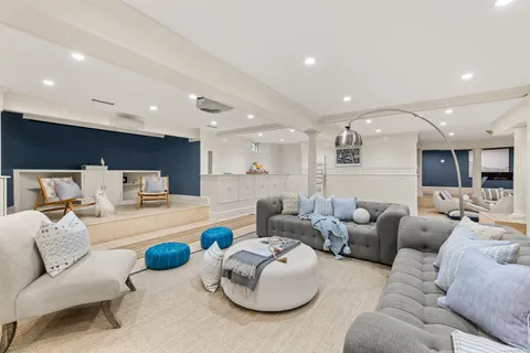 a living room with furniture and kitchen view