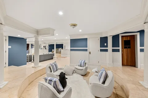 a bedroom with furniture and a view of living room