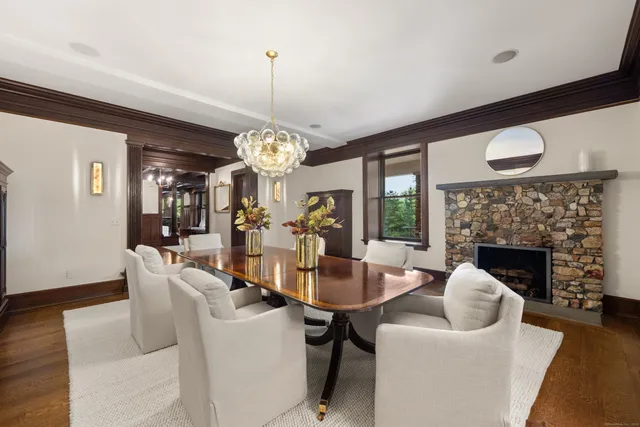 a living room with furniture a chandelier and a fireplace