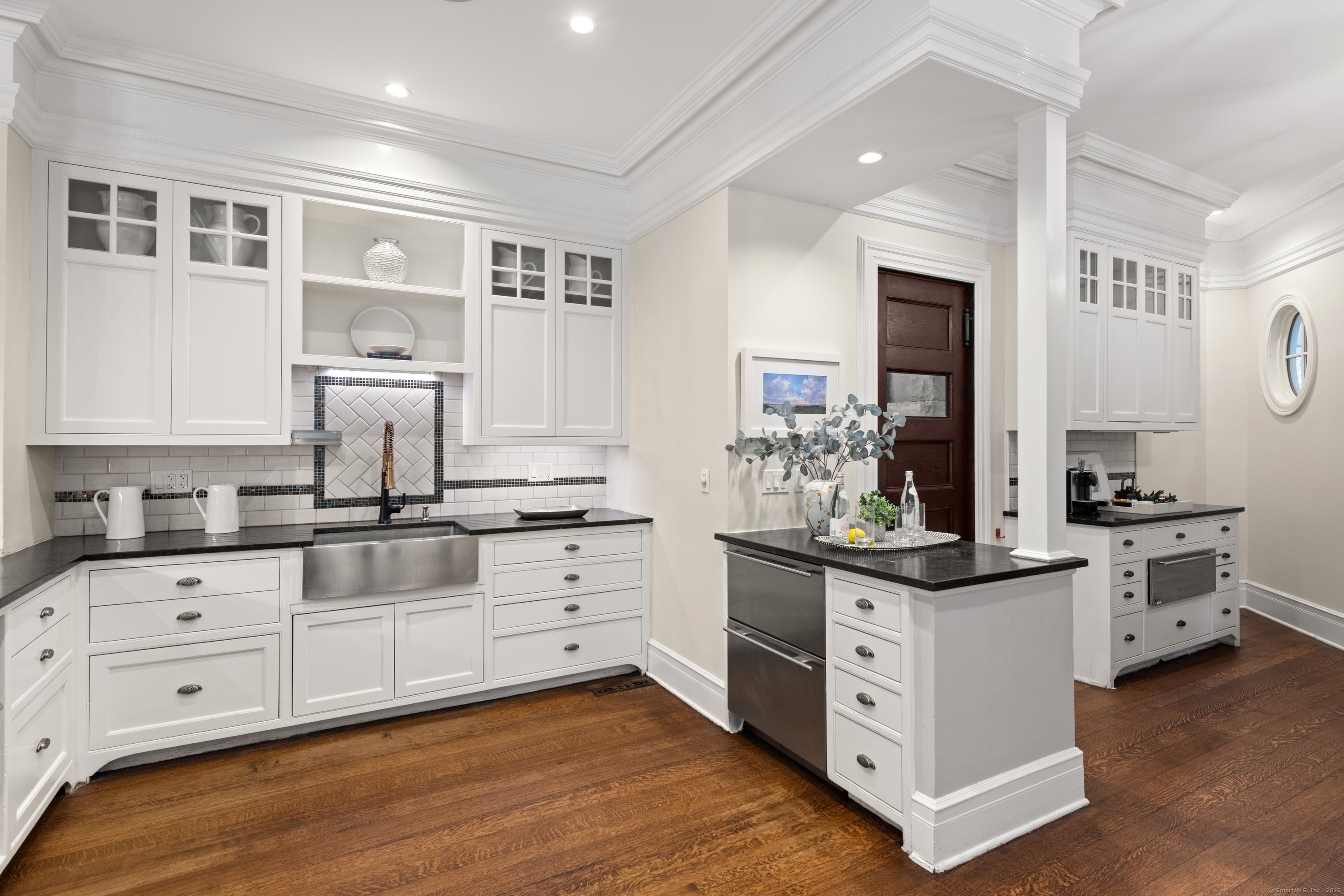 249 Greens Farms Road Westport, CT 06880 - Photo 9 of 40 a kitchen with white cabinets and white appliances