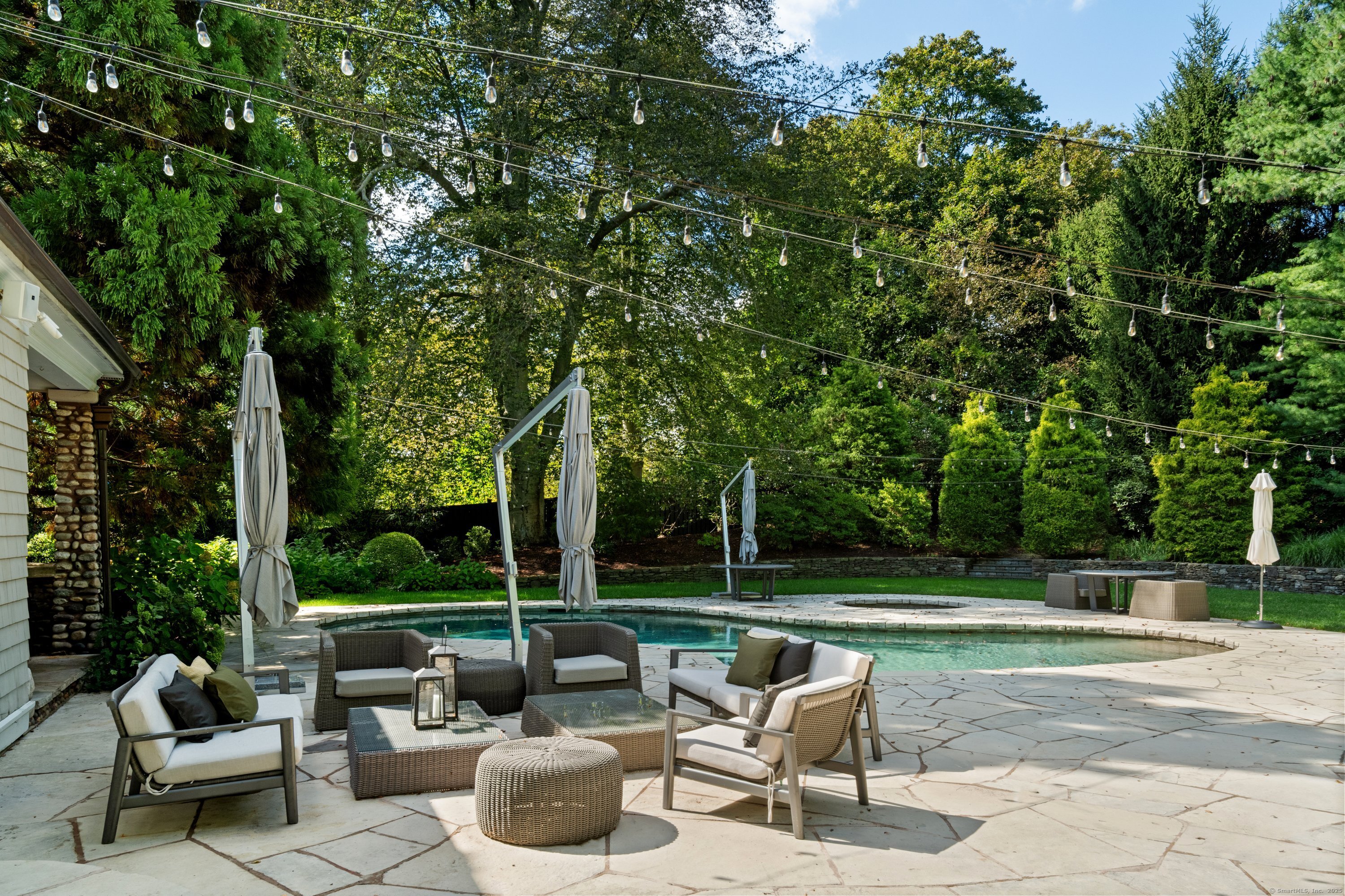 249 Greens Farms Road Westport, CT 06880 - Photo 9 of 40 a view of a patio with couches and a table and chairs with garden view