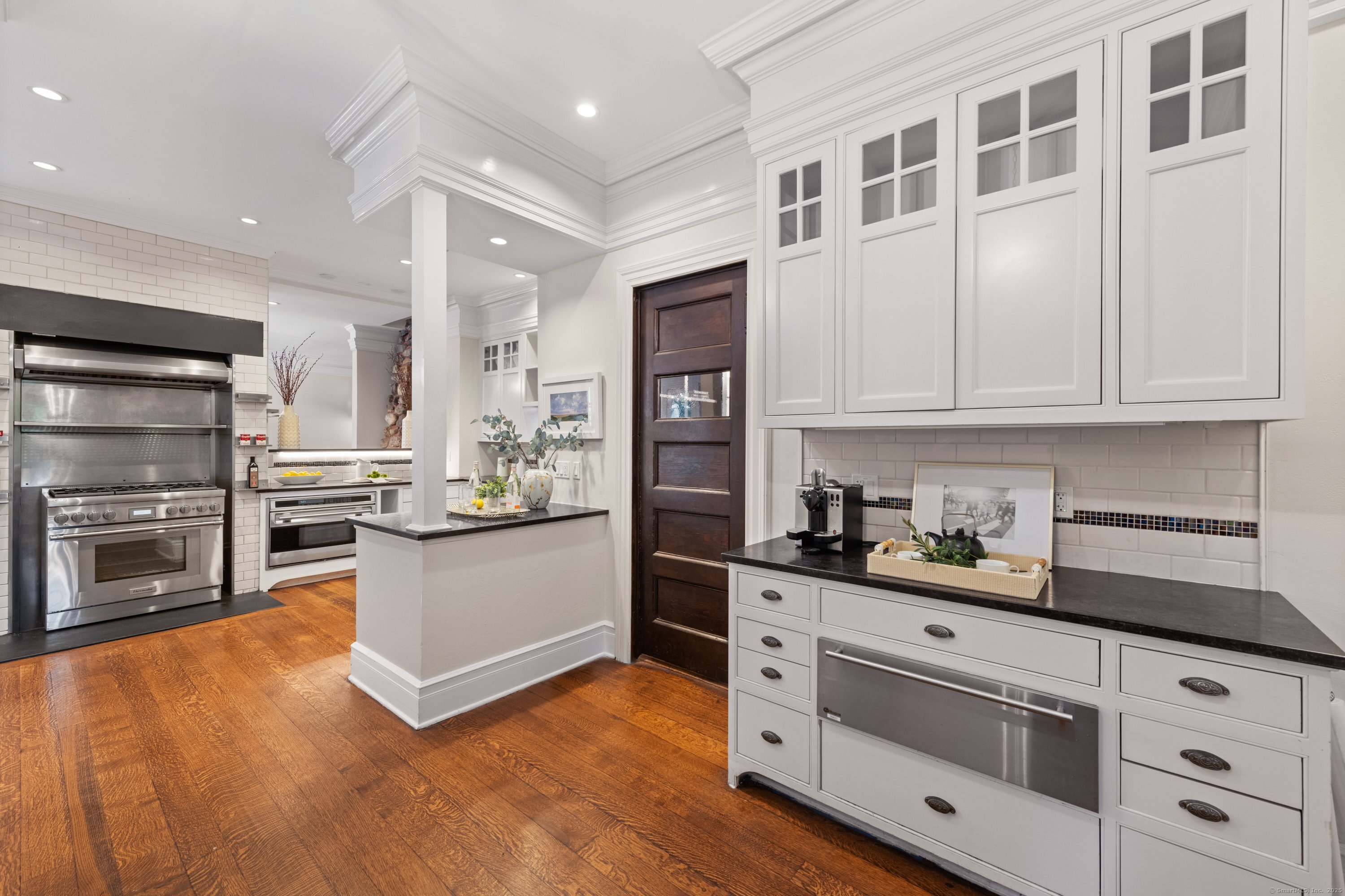249 Greens Farms Road Westport, CT 06880 - Photo 10 of 40 a kitchen with stainless steel appliances kitchen island granite countertop a stove and cabinets