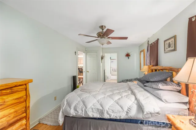 a bedroom with a bed and a ceiling fan