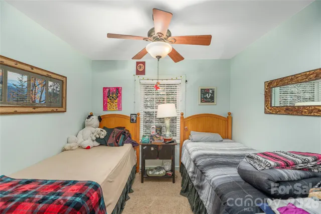 a bedroom with two beds and a chandelier