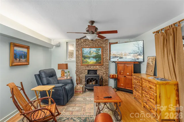 a living room with furniture a fireplace and a flat screen tv
