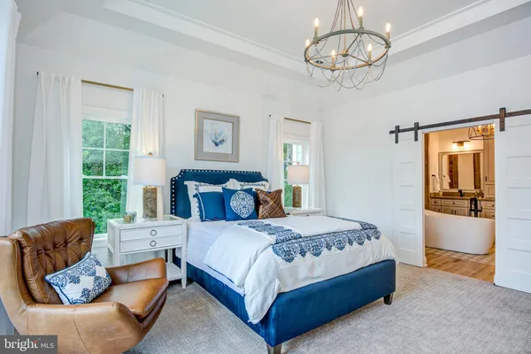 a bedroom with a bed couch and window