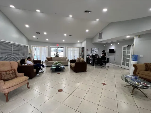 a living room with furniture a table and chairs