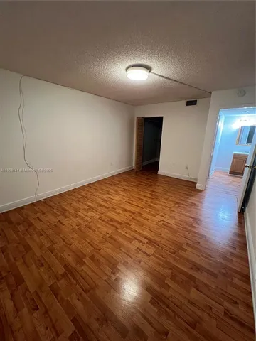 an empty room with wooden floor
