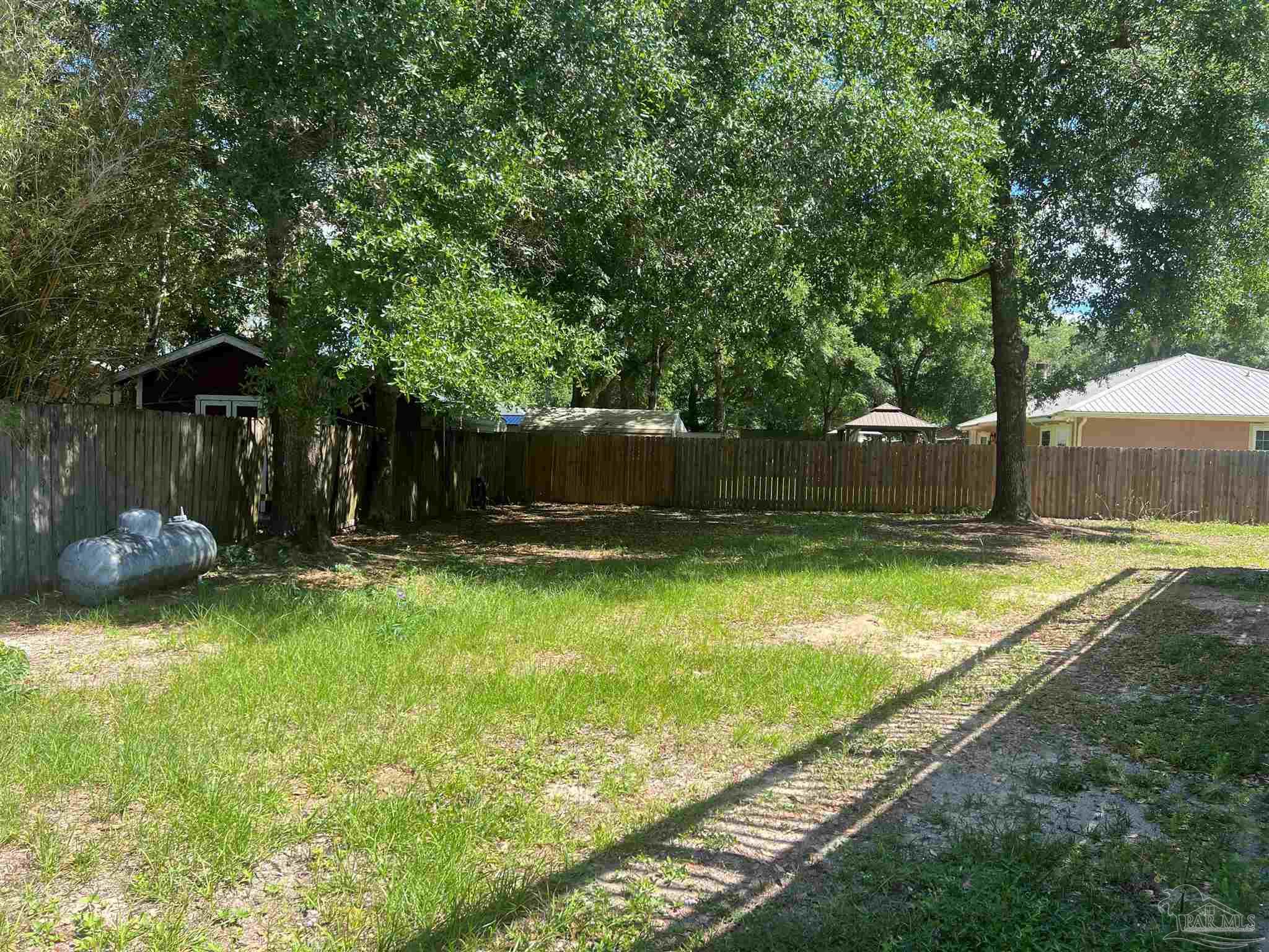 3111 Holley Point Road Navarre, FL 32566 - Photo 21 of 23 a view of a backyard with swimming pool