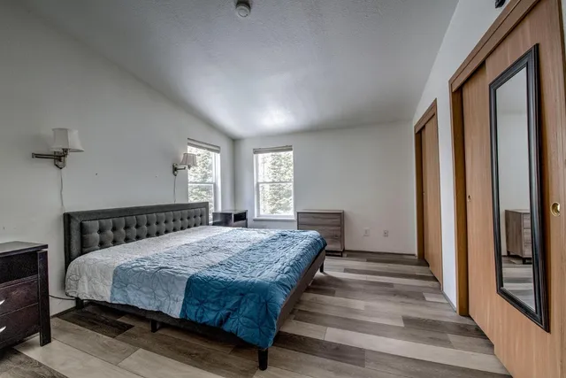 a bedroom with a large bed and a window