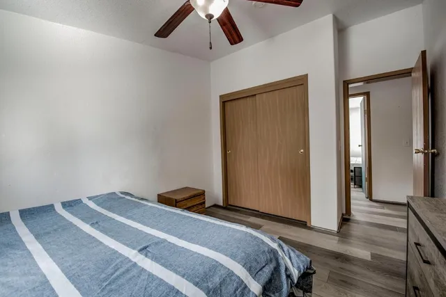 a bedroom with a bed and wooden floor