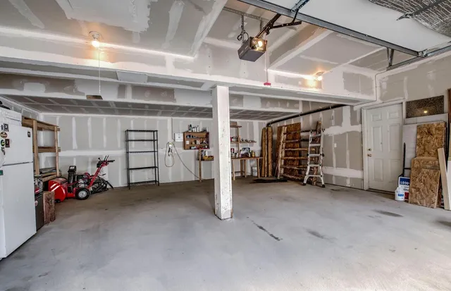 a view of a garage with rack and bicycle