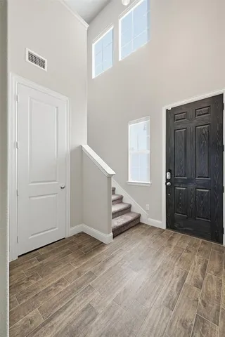 a view of an empty room with closet and a window