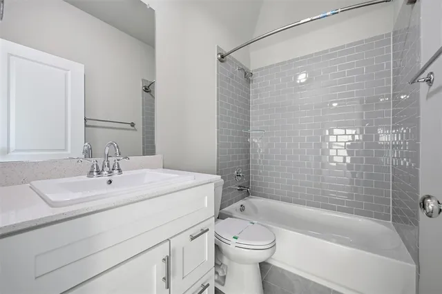 a bathroom with a sink mirror toilet and bathtub