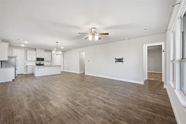 a view of a kitchen with a sink and a refrigerator